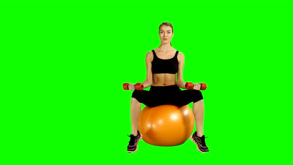 Sport Sitting on Pilates Ball and Exercising with Dumbbells. Green Screen