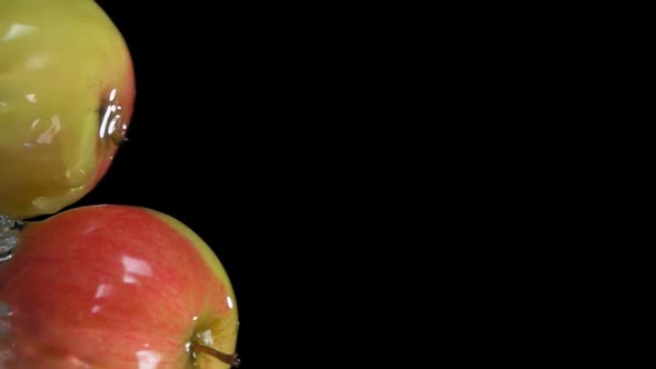 Super Closeup of Fresh Apples Bouncing Horizontally From Water with Splashes