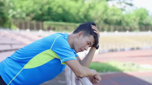 Sportsman Leaning On The Railing And Resting