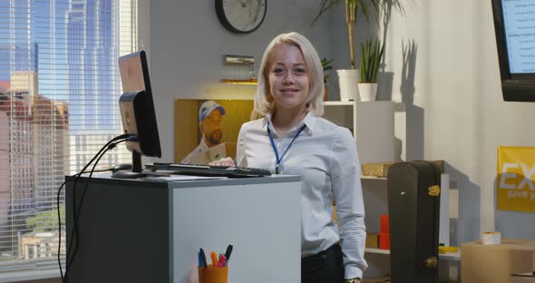 Customer Service Manager Standing By Desk