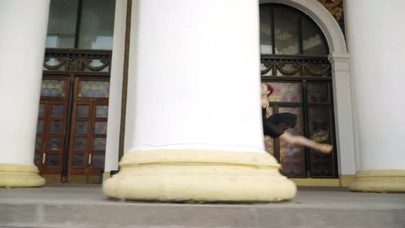 Camera Follows Slim Ballerina Running and Jumping Along White Columns Outdoors