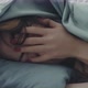 Closeup of the Face of a Woman Who Lies in Bed Her Head is Hidden Under the Covers - VideoHive Item for Sale