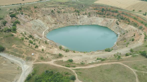 Aerial View of Abandoned Copper Mine Filled with Water, Surrounded By Fields, Tsar Asen, Bulgaria