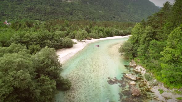 Aerial view of a group of people doing white water rafting in Soca river.