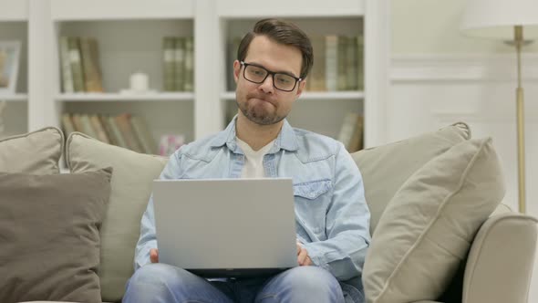 Angry Young Man Having Loss on Laptop at Home