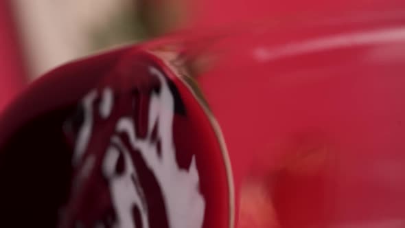 Vertical video, Close-up: red wine is poured into a glass