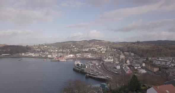 Low aerial push in shot of Oban town towards the Ferry Terminal,ing North