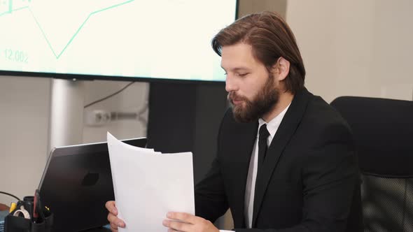 Two Businessmen in Suits Having a Discussion at Office