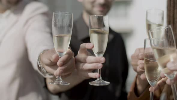 Closeup Shot of Peoples Hands Clinking Glasses of Champagne