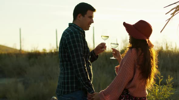 Couple Holding Hands and Tasting White Wine