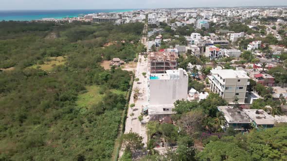 Aerial drone showing Playa Del Carmen, Mexico. Massive jungle, trees, ocean.