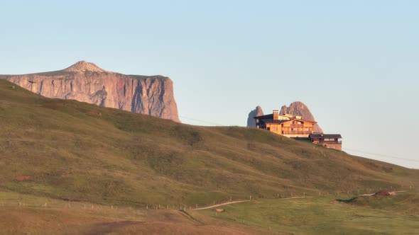 Dolomites mountains peaks with a hiking path on a summer sunrise