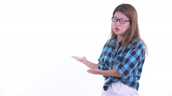 Stressed Young Asian Hipster Woman Showing To the Back