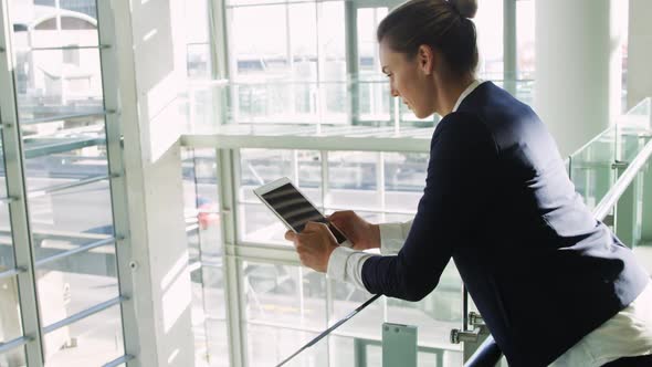 Businesswoman using tablet in modern office building