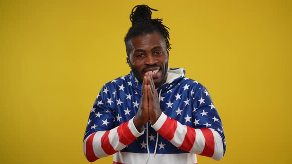 Front View Portrait of Joyful African American Man Asking for Favor Posing at Yellow Background