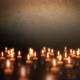 Candles lights on a wet grunge floor in a dark room. Dolly shot. - VideoHive Item for Sale