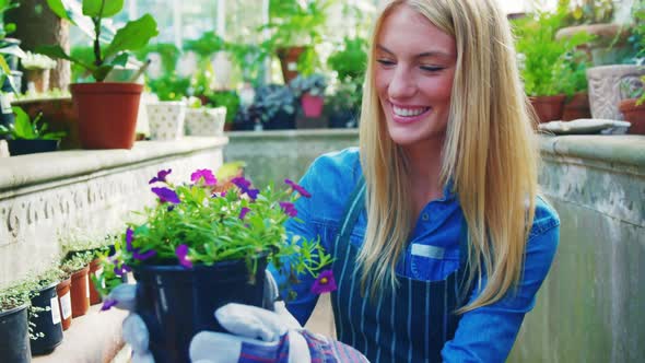 Beautiful woman carrying flower plant