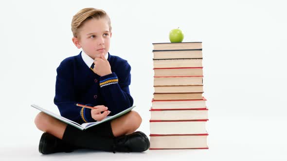 Thoughtful schoolboy doing her homework