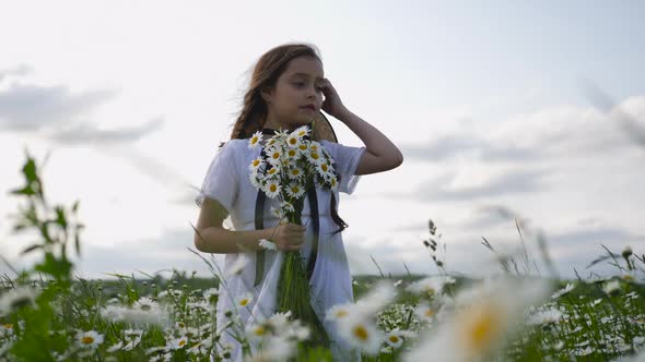 Girl in a White Dress of Seven Years with Big Eyes