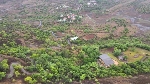 small village near by river rainy sesone drone shot bird eye view