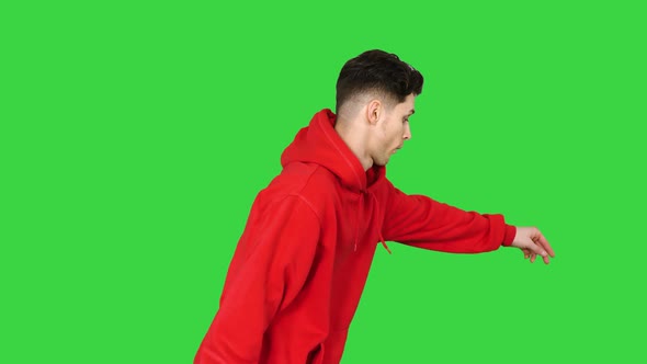 Handsome Young Man Dancing in Red Hoody on a Green Screen, Chroma Key