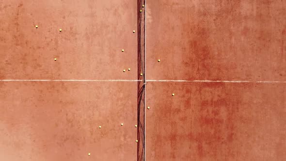 Overhead Shot of a Tennis Player Who Stands and Hits the Ball During a Sports Practice on an Outdoor