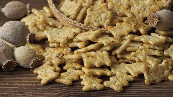 Baked party poppy seed crackers, dry poppy heads . Salty snacks