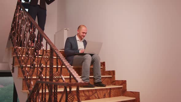 Overworked Business Man Smoking Sitting on Stairs