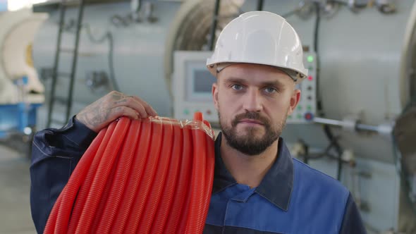  Plant Worker with Roll of HDPE Pipes