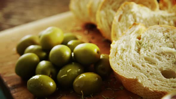 Green olives, oil, soy sauce and bread