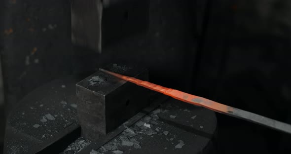 Blacksmith Uses a Hydraulic Hammer to Forge Hot Metal in His Workshop Automatic Hammer is Shaping