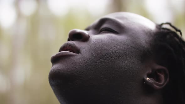 Close Up Shot of an African Man Taking a Big Breath and Looking Up in the Sky. Slow Motion