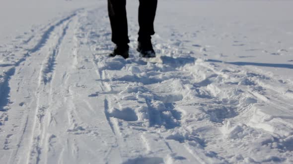A Man Walks in the Snow in Winter