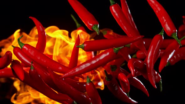 Super Slow Motion Shot of Red Chilli Peppers and Fire at 1000Fps