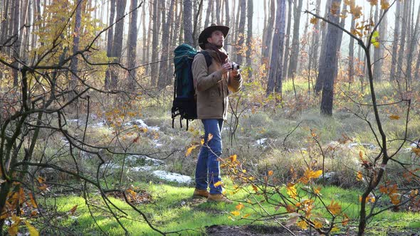 Tourist Travels in the Forest and Takes Photos