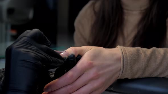 Professional Manicurist in Black Gloves Colours Fingernail