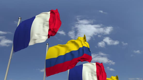 Flags of Colombia and France Against Blue Sky