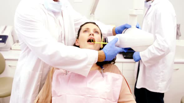 Dentist taking x-ray of patients teeth