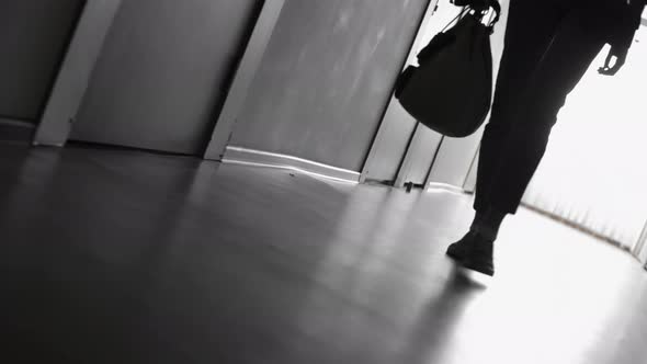 Silhouette of Woman Walking in Hallway
