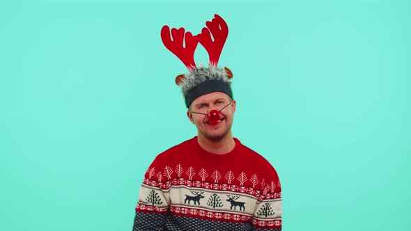 Cheerful Lovely 30s Years Old Man Wears Red New Year Sweater and Hat Smiling Looking at Camera