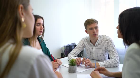 Managers Laughing at Joke While Brainstorming at Business Meeting