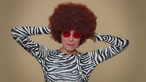 Cheerful Lovely Pretty Young Woman with Brown Lush Wig in Red Sunglasses Smiling Looking at Camera