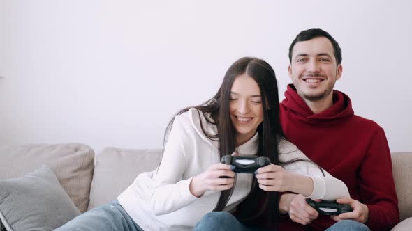 A Pretty Girl and a Boy Are Playing Video Games in the Living Room