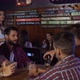 Waitress bringing a beer to a group of guy at a bar in Patagonia Argentina - VideoHive Item for Sale
