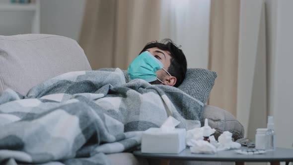 Sick Guy Man Suffering From Illness Feeling Unwell Flu Coronavirus Symptoms Wears Medical Mask Lies
