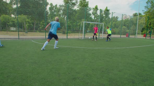 Soccer Player Assisting to Football Striker on Pitch at Daybreak