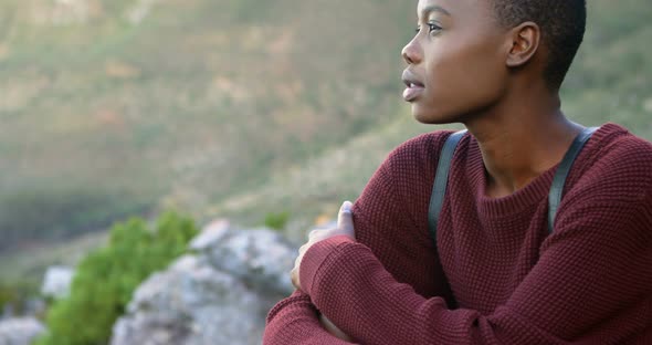 Woman sitting on a rock at countryside 4k