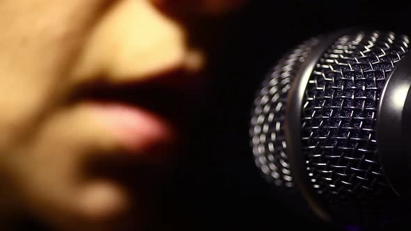 Woman singing to a microphone