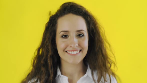 Closeup Beauty Portrait of Woman Is Looking at Camera, Biting Lip and Smiling