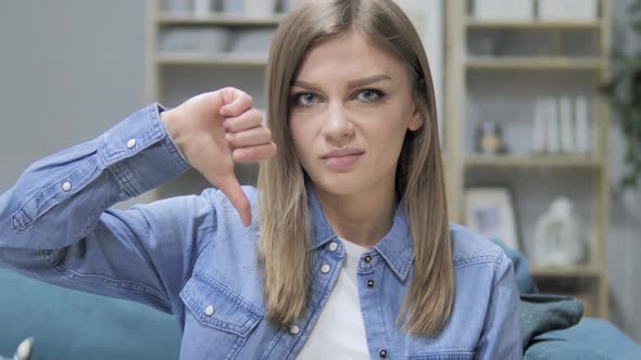 Thumbs Down By Young Girl in Creative Office